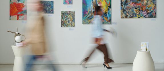 people walking in an art gallery