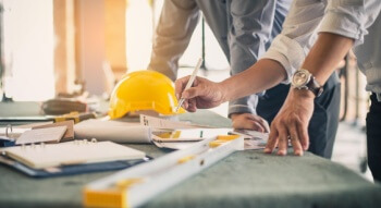 workers looking at plans on a construction site